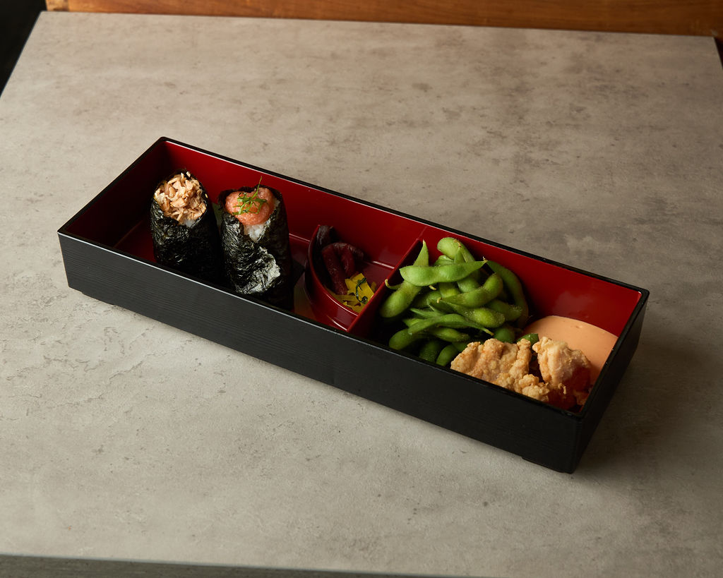 Onigiri bento box with rice balls, edamame and pickles